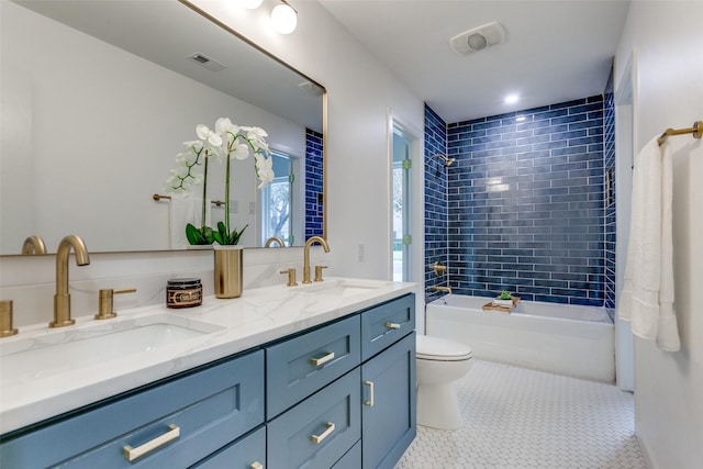 bathroom with toilet, tile patterned flooring, tub / shower combination, and a sink