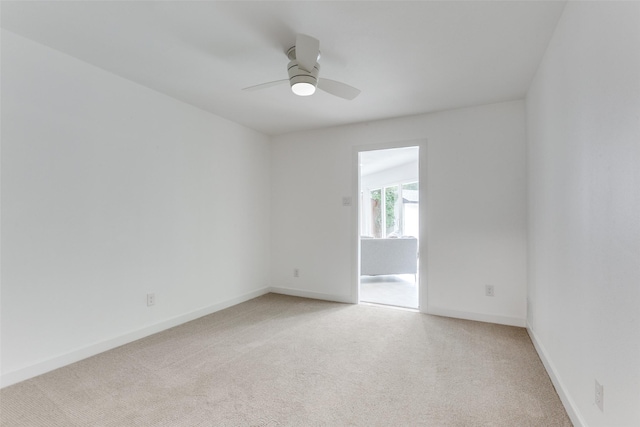 unfurnished room with light carpet, ceiling fan, and baseboards