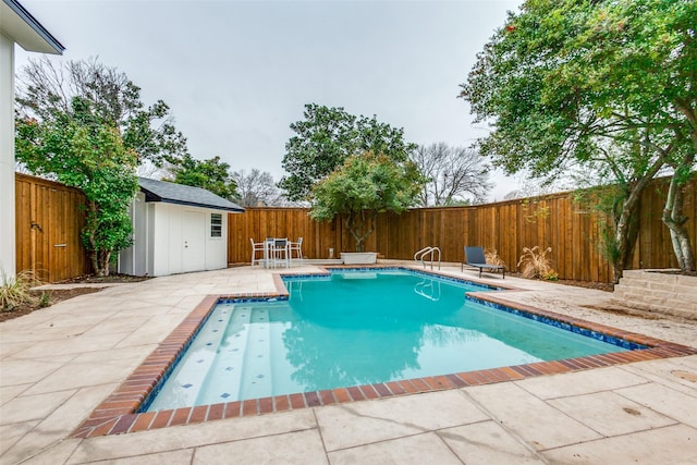 view of pool with an outbuilding, a patio, a fenced backyard, a storage shed, and a fenced in pool