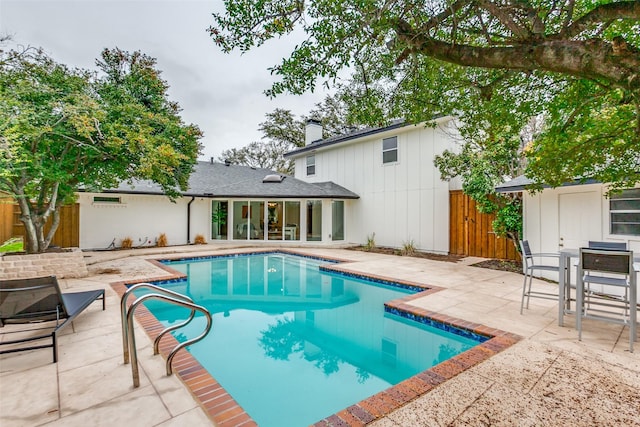 view of swimming pool featuring a fenced in pool, a patio area, and fence