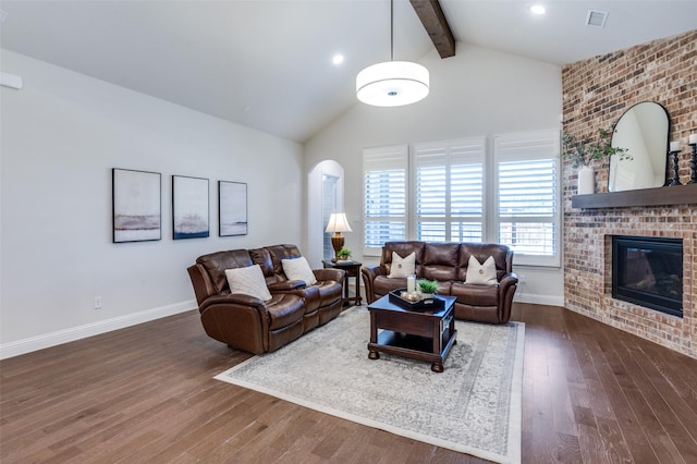 living area featuring beam ceiling, a fireplace, visible vents, dark wood-type flooring, and baseboards