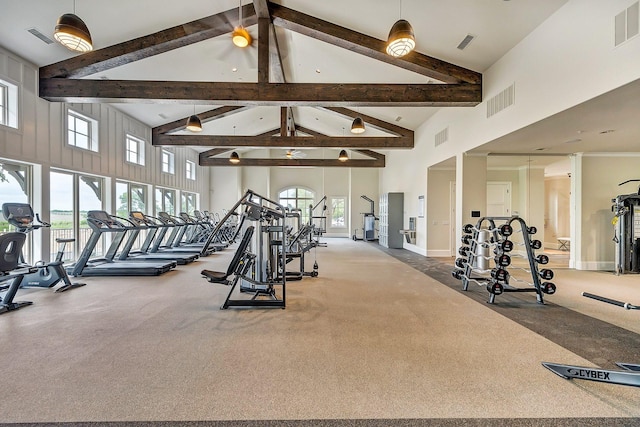 exercise room featuring high vaulted ceiling and visible vents