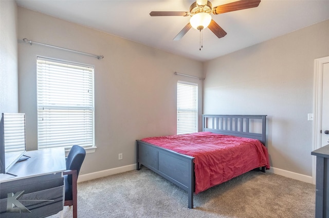 bedroom featuring baseboards, a ceiling fan, and light colored carpet