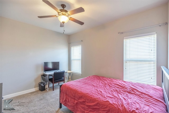 carpeted bedroom with a ceiling fan and baseboards