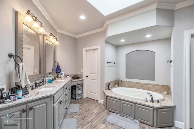 full bath with wood finished floors, a sink, a bath, double vanity, and crown molding