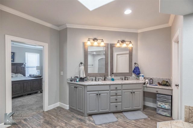 full bath with ornamental molding, double vanity, a sink, and ensuite bathroom