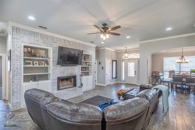 living area featuring dark wood-style floors, a fireplace, visible vents, and baseboards