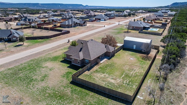 drone / aerial view featuring a residential view and a mountain view