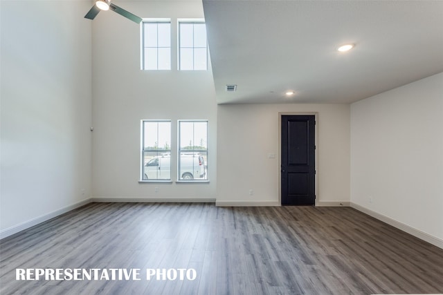 unfurnished living room featuring light wood-type flooring, visible vents, baseboards, and recessed lighting