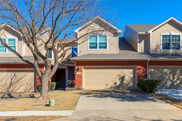 view of front of property featuring concrete driveway, brick siding, and roof with shingles