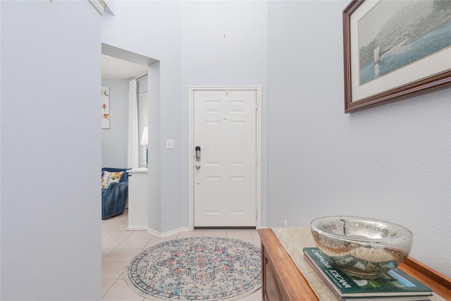 entrance foyer featuring light tile patterned floors and baseboards