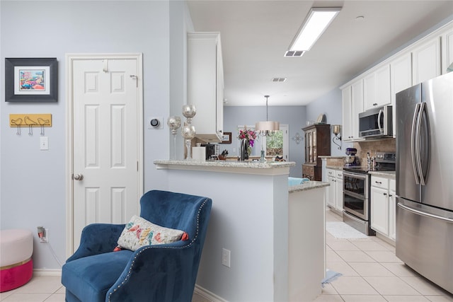 kitchen featuring decorative light fixtures, stainless steel appliances, visible vents, white cabinetry, and a peninsula