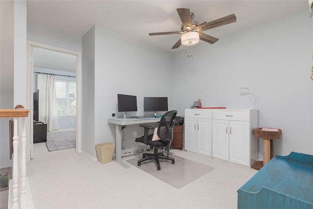 office with ceiling fan, baseboards, and light colored carpet