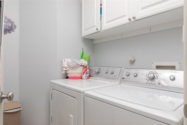 laundry area with washer and clothes dryer and cabinet space