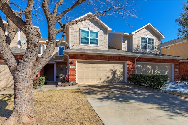 view of front of house with driveway, brick siding, and an attached garage