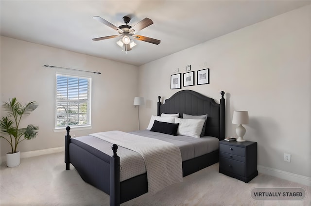 bedroom with light carpet, ceiling fan, and baseboards