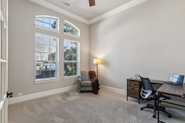 home office with baseboards, visible vents, a ceiling fan, light colored carpet, and crown molding