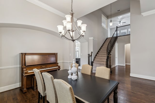 dining area featuring baseboards, stairs, arched walkways, and dark wood finished floors