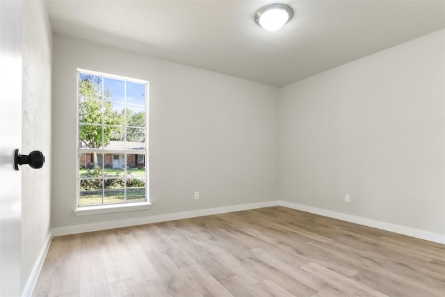 unfurnished room featuring light wood-type flooring and baseboards