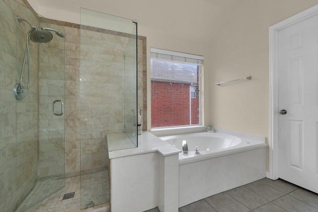 bathroom with a stall shower, tile patterned flooring, and a garden tub