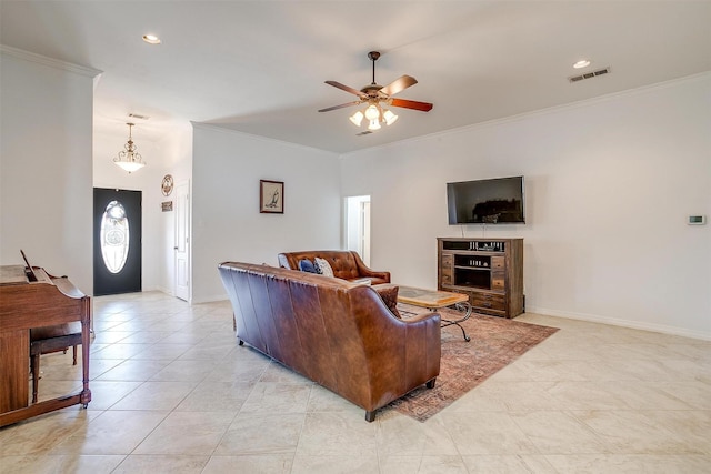 living area with visible vents, crown molding, baseboards, and ceiling fan