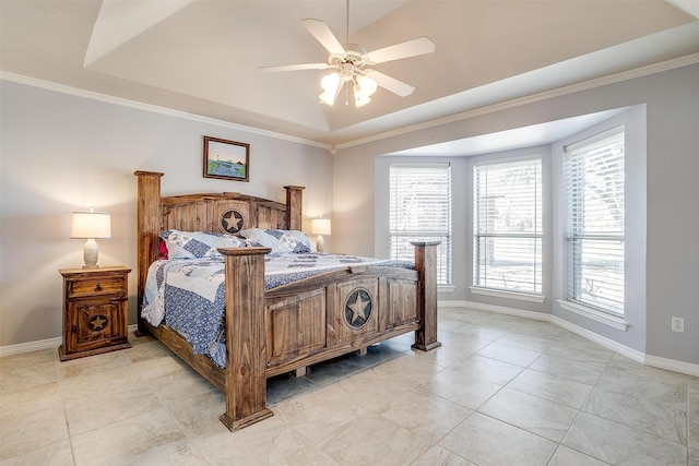 bedroom featuring baseboards, a raised ceiling, and ornamental molding