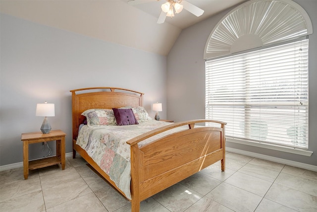 bedroom with light tile patterned floors, ceiling fan, baseboards, and vaulted ceiling