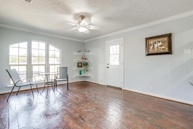 unfurnished room with a textured ceiling, ceiling fan, wood finished floors, and crown molding