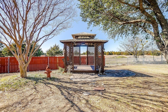 view of yard with a fenced backyard and a gazebo