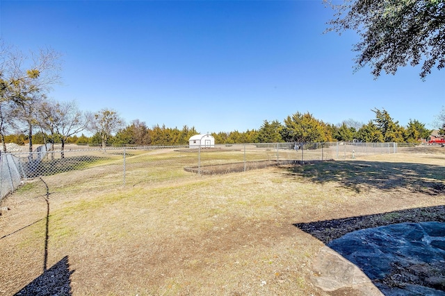 view of yard with fence and a rural view