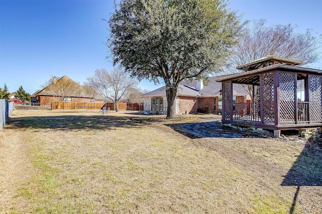 view of yard featuring a fenced backyard and a gazebo