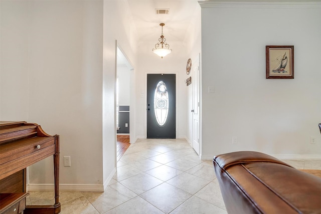 foyer with visible vents, baseboards, and light tile patterned flooring