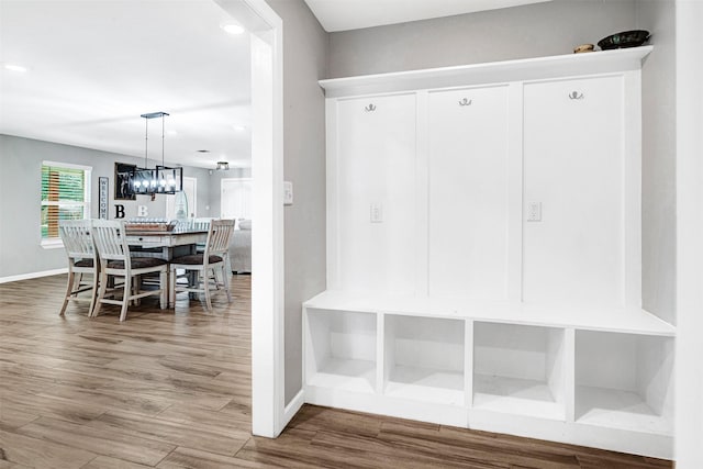 mudroom featuring wood finished floors and baseboards