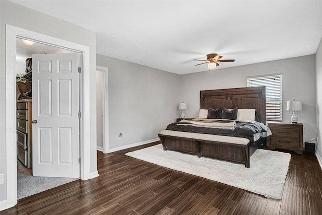 bedroom with baseboards, dark wood-type flooring, and a ceiling fan