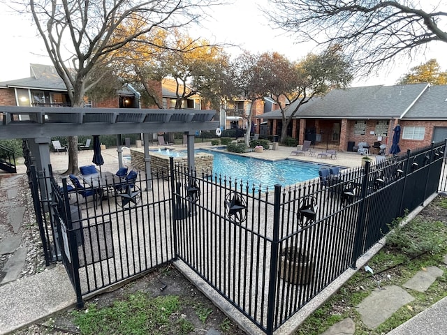 community pool with fence and a patio