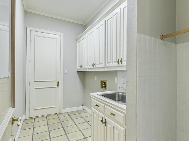 laundry area featuring crown molding, light tile patterned floors, hookup for a washing machine, a sink, and baseboards