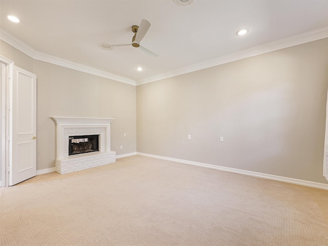 unfurnished living room featuring a brick fireplace, light carpet, crown molding, and baseboards