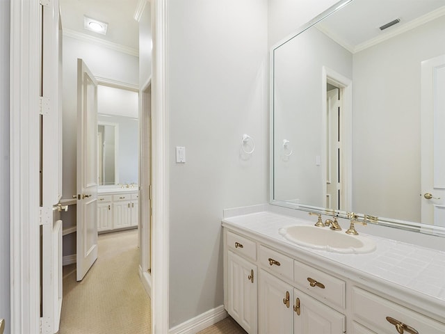 bathroom with ornamental molding, visible vents, vanity, and baseboards