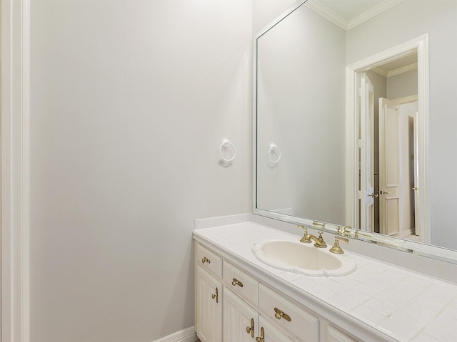 bathroom with baseboards, crown molding, and vanity