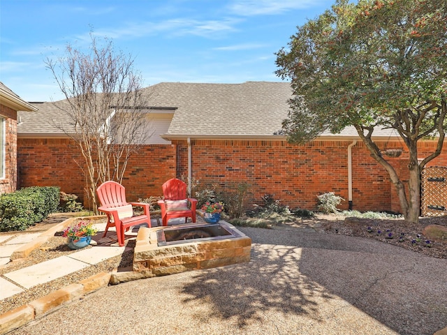 view of yard featuring a fire pit and a patio area