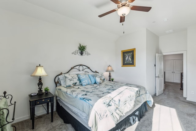 bedroom with light carpet, ceiling fan, vaulted ceiling, and baseboards