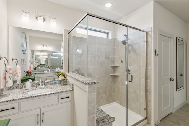 full bathroom featuring a shower stall and vanity