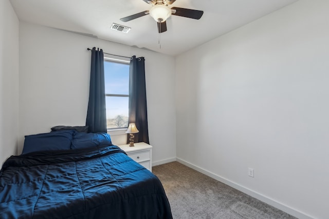 bedroom featuring baseboards, visible vents, a ceiling fan, and light colored carpet