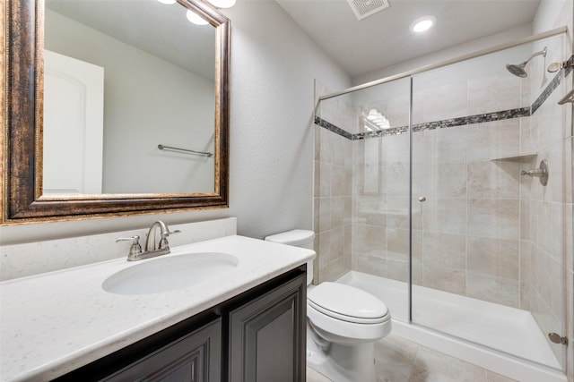 full bath with toilet, a stall shower, vanity, and visible vents