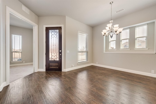 foyer with dark wood-type flooring, visible vents, and a healthy amount of sunlight