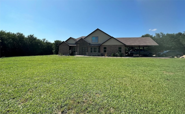 view of front of house with an attached carport and a front yard