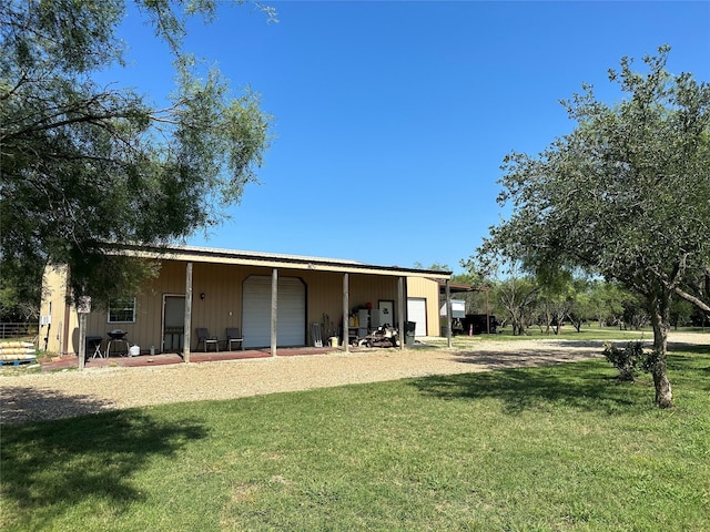 exterior space with a garage, an outbuilding, and a pole building