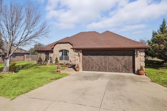 view of front of property with a garage, brick siding, fence, concrete driveway, and a front lawn