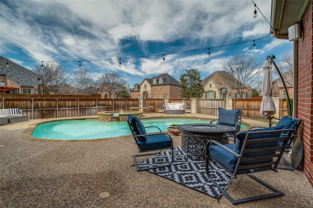 view of pool with an outdoor living space with a fire pit, a patio area, a fenced backyard, and a pool with connected hot tub