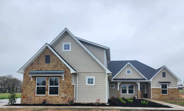 craftsman house featuring stone siding and board and batten siding